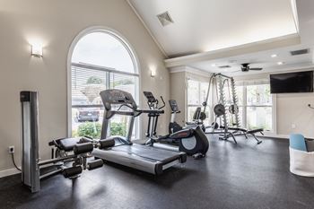 A spacious home gym with a variety of exercise equipment.